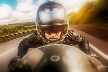 Image showing Biker racing on the road