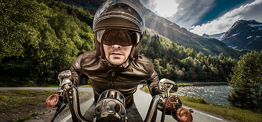 Image showing Biker racing on the road