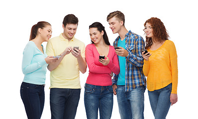 Image showing group of smiling teenagers with smartphones