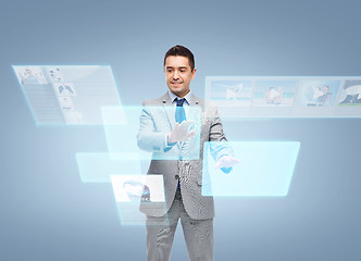 Image showing businessman in suit working with virtual screens