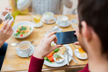 Image showing friends with smartphones taking picture of food