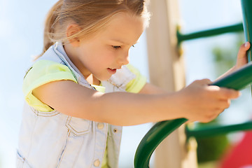 Image showing happy little girl climbing on children playground