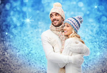 Image showing smiling couple in winter clothes hugging
