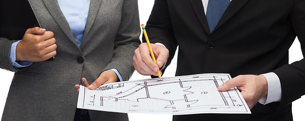 Image showing businesspeople with clipboard, blueprint, helmet