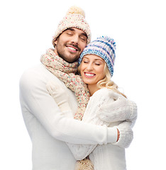 Image showing smiling couple in winter clothes hugging