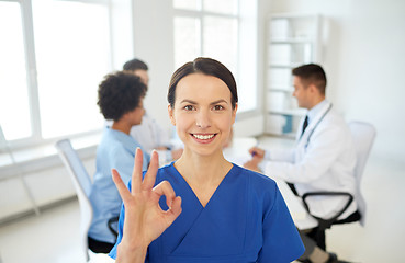 Image showing happy doctor over group of medics at hospital