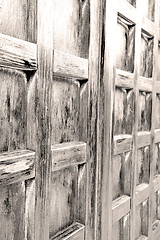 Image showing home texture of a brown antique wooden old door in italy   europ
