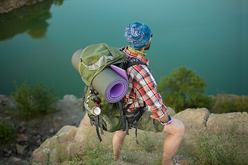 Image showing Young caucasian man with backpack on the top of hill