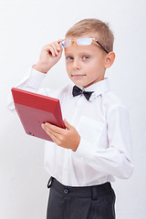 Image showing Portrait of teen boy with calculator on white background