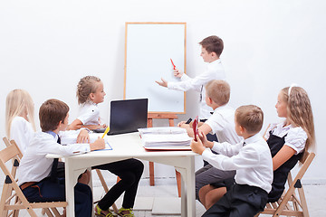 Image showing The group of teenagers sitting in a business meeting