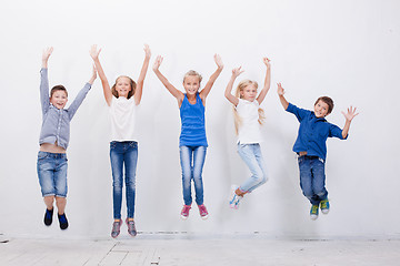 Image showing Group of happy young people jumping  on white background