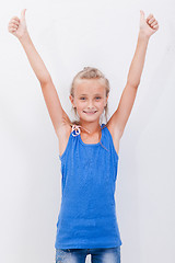 Image showing Portrait of a beautiful girl showing thumbs up on white