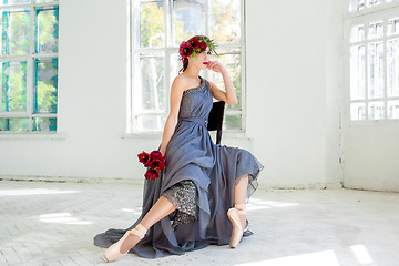 Image showing The beautiful ballerina sirtting in long gray dress 