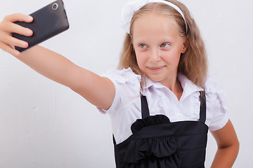 Image showing pretty teen girl taking selfies with her smart phone