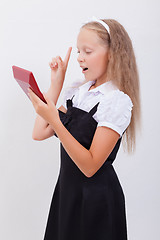 Image showing Portrait of teen girl with calculator on white background