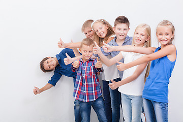 Image showing The smiling teenagers showing okay sign on white 