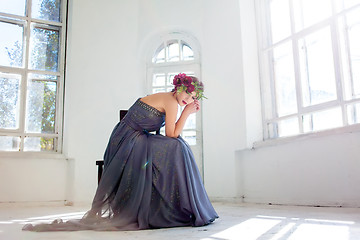 Image showing The beautiful ballerina sirtting in long gray dress 