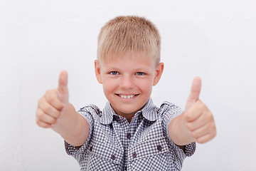 Image showing Portrait of happy boy showing thumbs up gesture