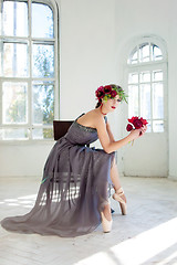 Image showing The beautiful ballerina sirtting in long gray dress 