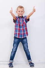 Image showing Portrait of happy boy showing thumbs up gesture