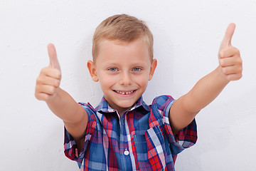 Image showing Portrait of happy boy showing thumbs up gesture