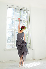 Image showing The beautiful ballerina dancing in long gray dress 