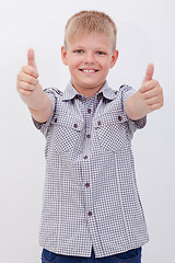 Image showing Portrait of happy boy showing thumbs up gesture