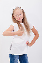 Image showing Portrait of a beautiful girl showing thumbs up on white