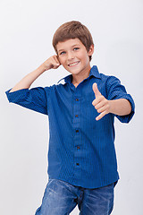 Image showing Happy young boy with calling gesture over white background