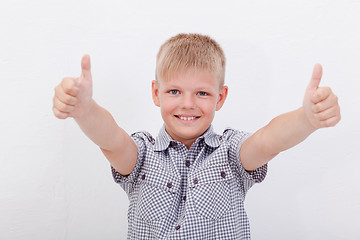 Image showing Portrait of happy boy showing thumbs up gesture