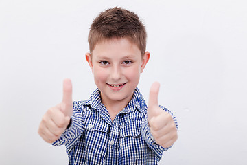 Image showing Portrait of happy boy showing thumbs up gesture