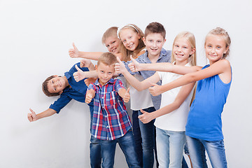 Image showing The smiling teenagers showing okay sign on white 