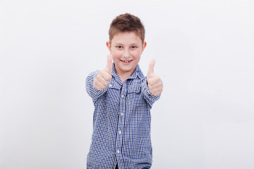 Image showing Portrait of happy boy showing thumbs up gesture