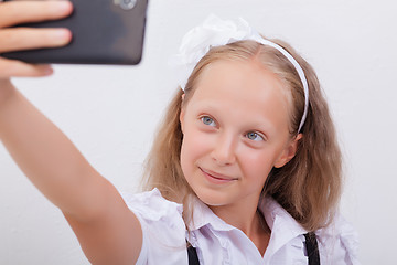 Image showing pretty teen girl taking selfies with her smart phone