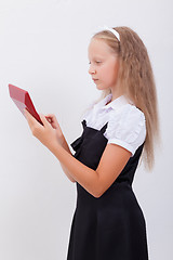 Image showing Portrait of teen girl with calculator on white background