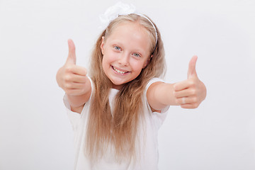 Image showing Portrait of a beautiful girl showing thumbs up on white