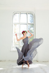 Image showing The beautiful ballerina dancing in long gray dress 