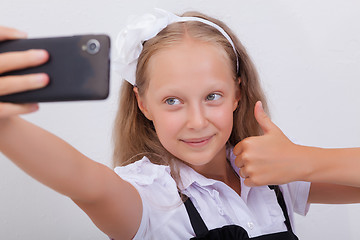 Image showing pretty teen girl taking selfies with her smart phone