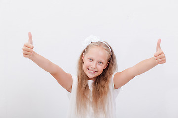 Image showing Portrait of a beautiful girl showing thumbs up on white