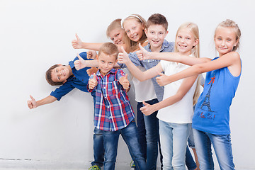 Image showing The smiling teenagers showing okay sign on white 