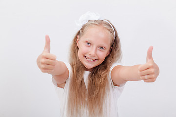 Image showing Portrait of a beautiful girl showing thumbs up on white