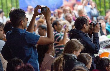 Image showing Spectators filming the event