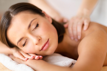 Image showing beautiful woman in spa salon getting massage