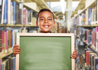 Image showing Smiling Hispanic Boy Holding Empty Chalk Board in Library