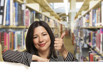 Image showing Hispanic Woman with Thumbs Up On White Board in Library