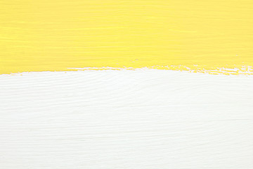 Image showing Stripe of yellow paint over white wooden background