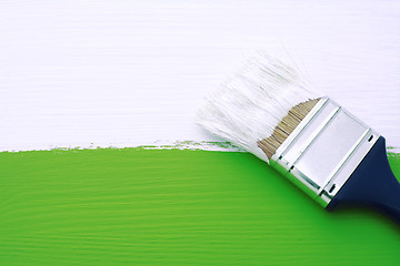 Image showing Painting green surface with white paint