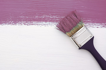 Image showing Stripe of plum paint with a paintbrush on white