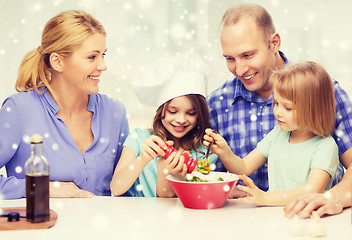 Image showing happy family with two kids making salad at home