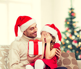 Image showing smiling daughter waiting for a present from father